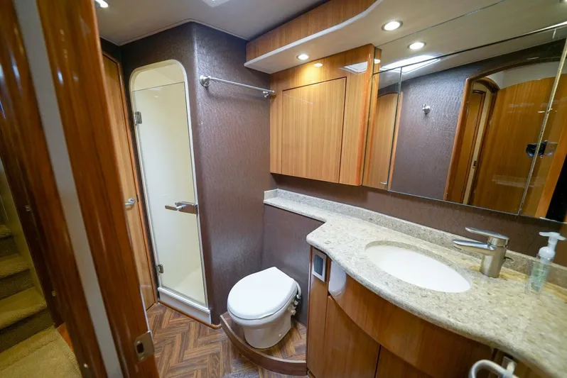 Synchronicity Yacht Photos Pics Luxurious bathroom in 2013 Viking 55 Convertible yacht with modern fixtures and wood accents.