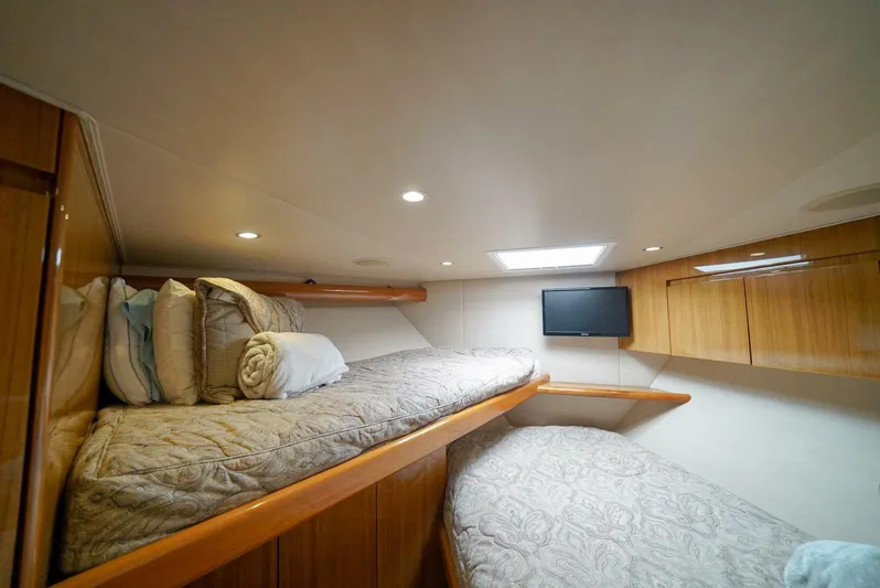 Synchronicity Yacht Photos Pics Cozy cabin interior of 2013 Viking 55 Convertible yacht with twin beds and TV.
