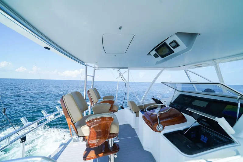 Synchronicity Yacht Photos Pics Luxurious 2013 Viking 55 Convertible yacht interior with ocean view and modern helm station.