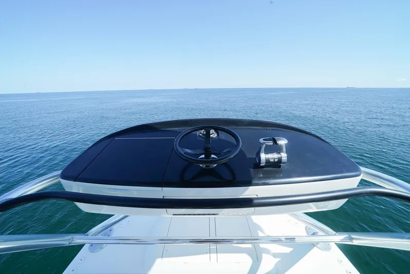 Synchronicity Yacht Photos Pics Viking 55 Convertible 2013 yacht helm overlooking calm ocean waters.