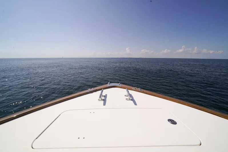 Synchronicity Yacht Photos Pics Bow view of 2013 Viking 55 Convertible yacht on open sea.