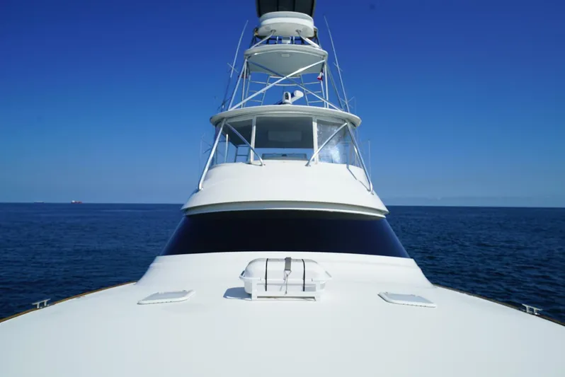 Synchronicity Yacht Photos Pics Viking 55 Convertible yacht, 2013 model, cruising on open sea under clear blue sky.