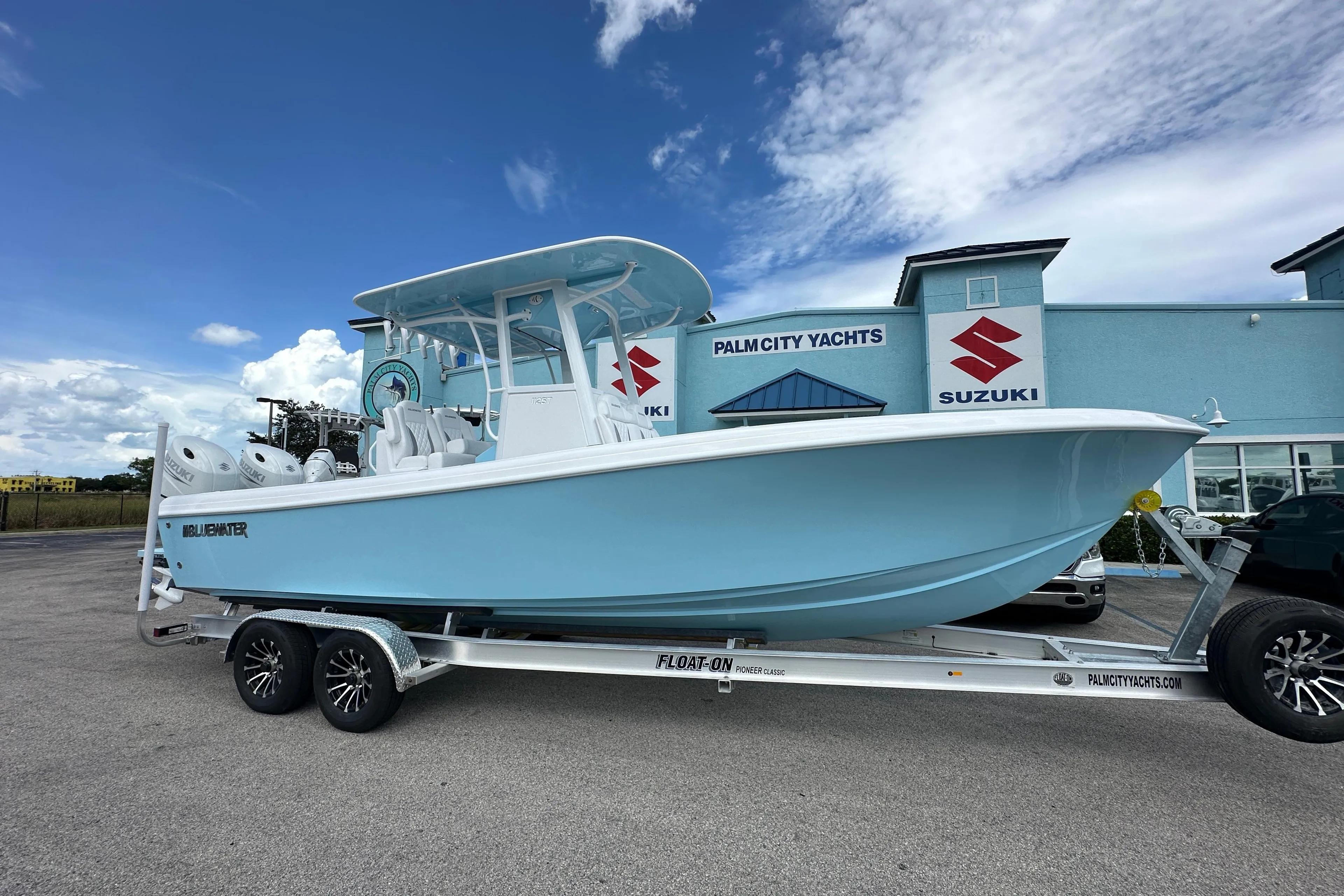 2026 Bluewater 25t boat on trailer at Palm City Yachts dealership.