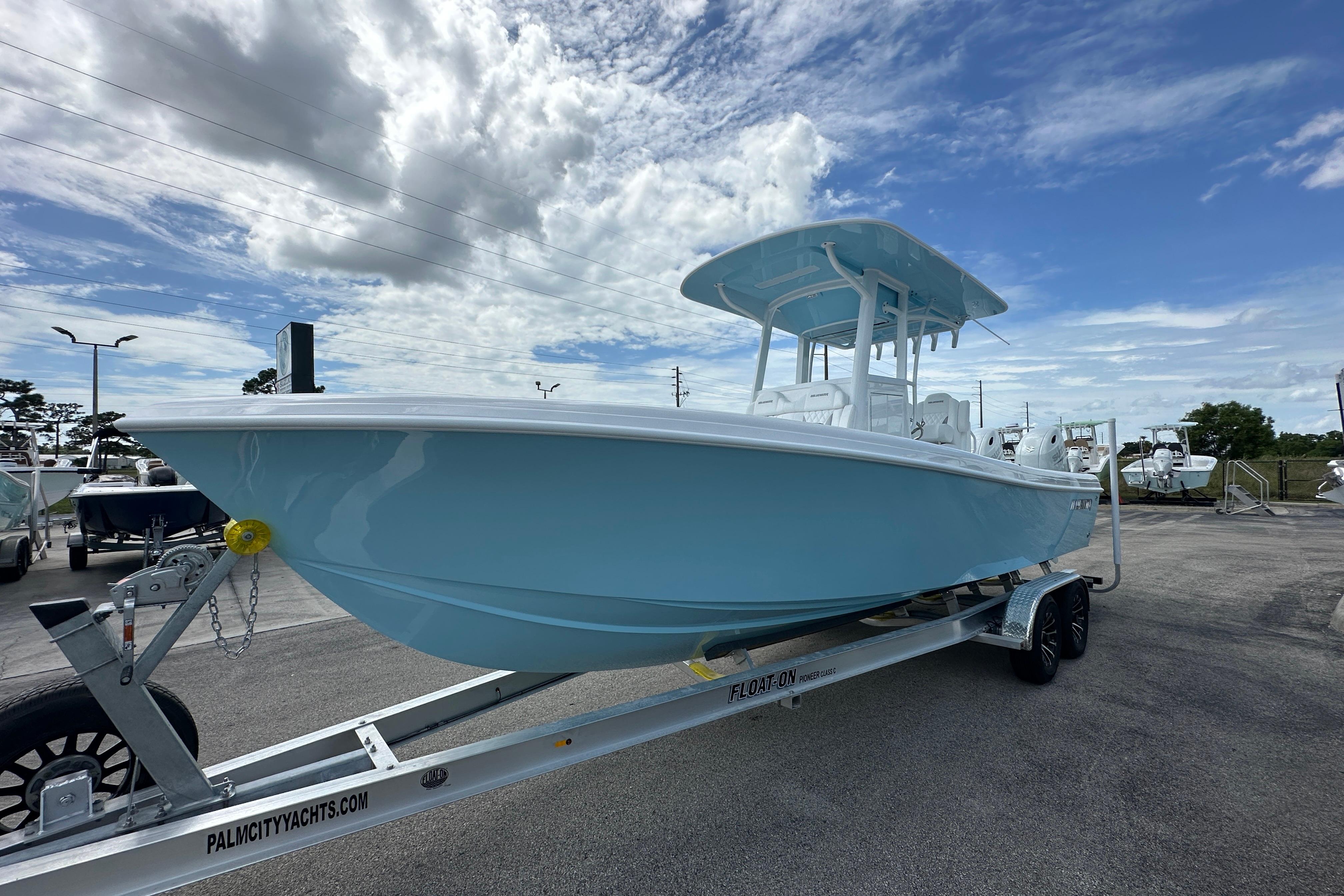 2026 Bluewater 25t boat on trailer under cloudy sky at dealership.