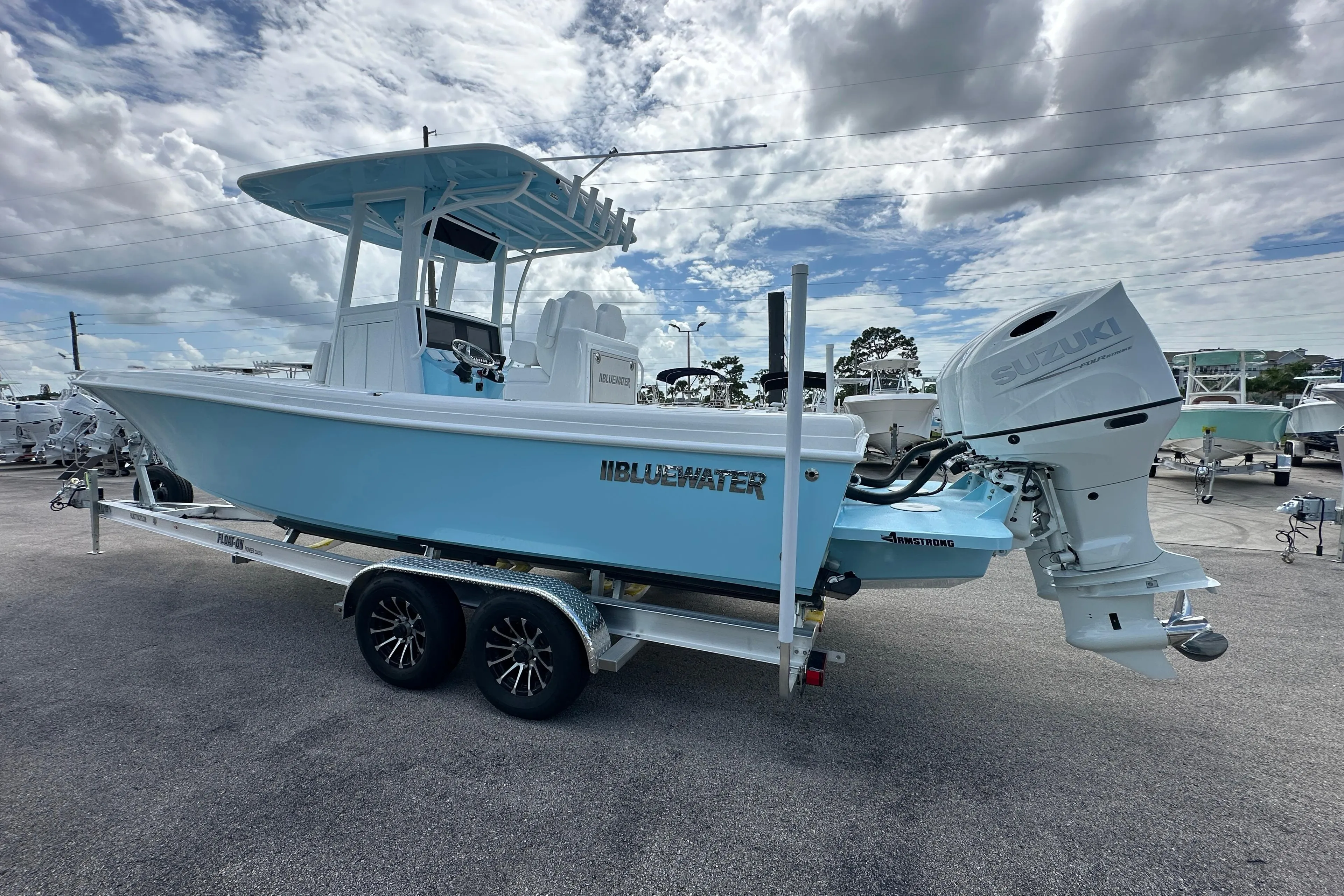 2026 Bluewater 25t boat on trailer with Suzuki outboard motor under cloudy sky.
