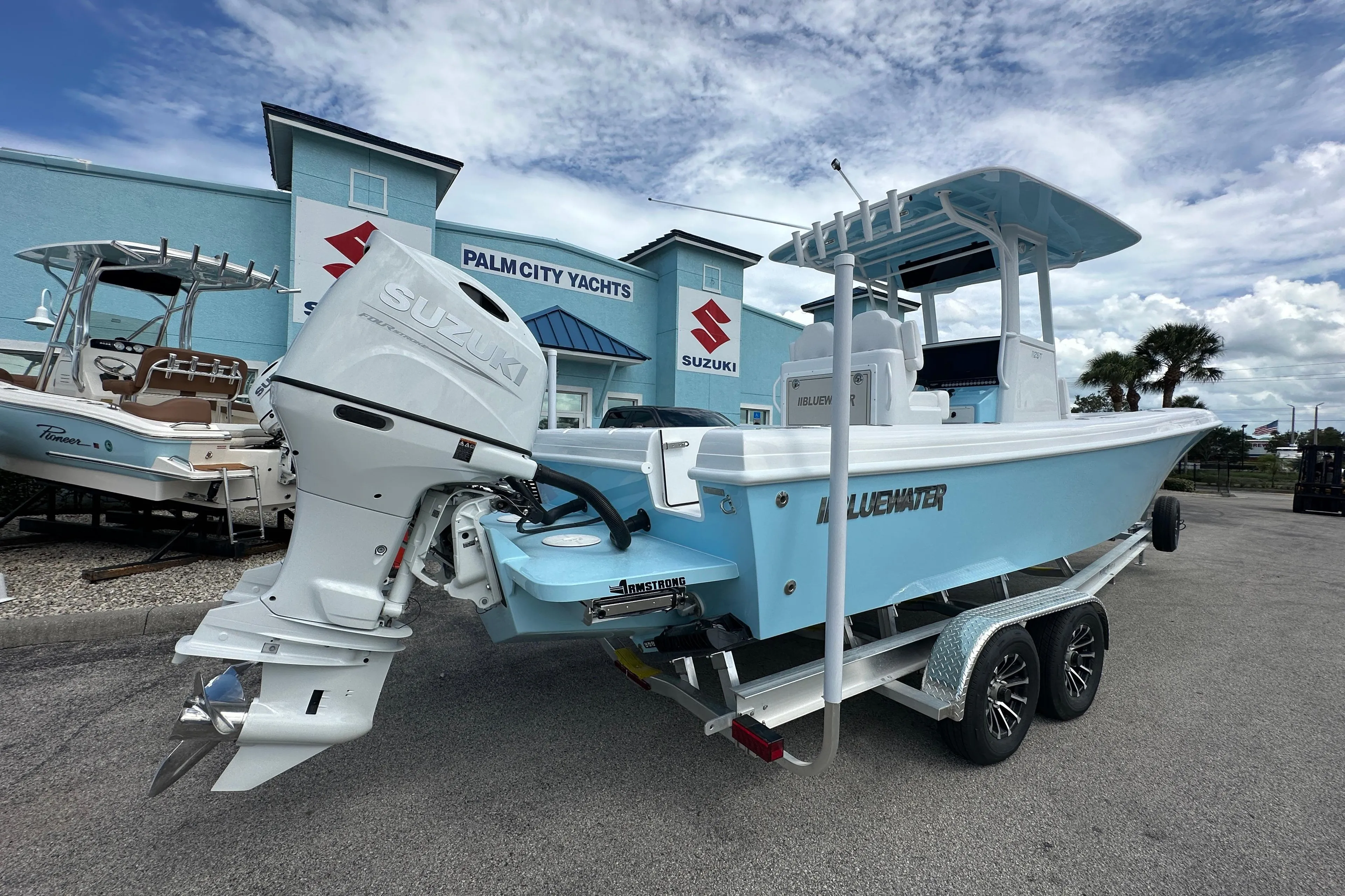 2026 Bluewater 25t boat with Suzuki engine at Palm City Yachts dealership.