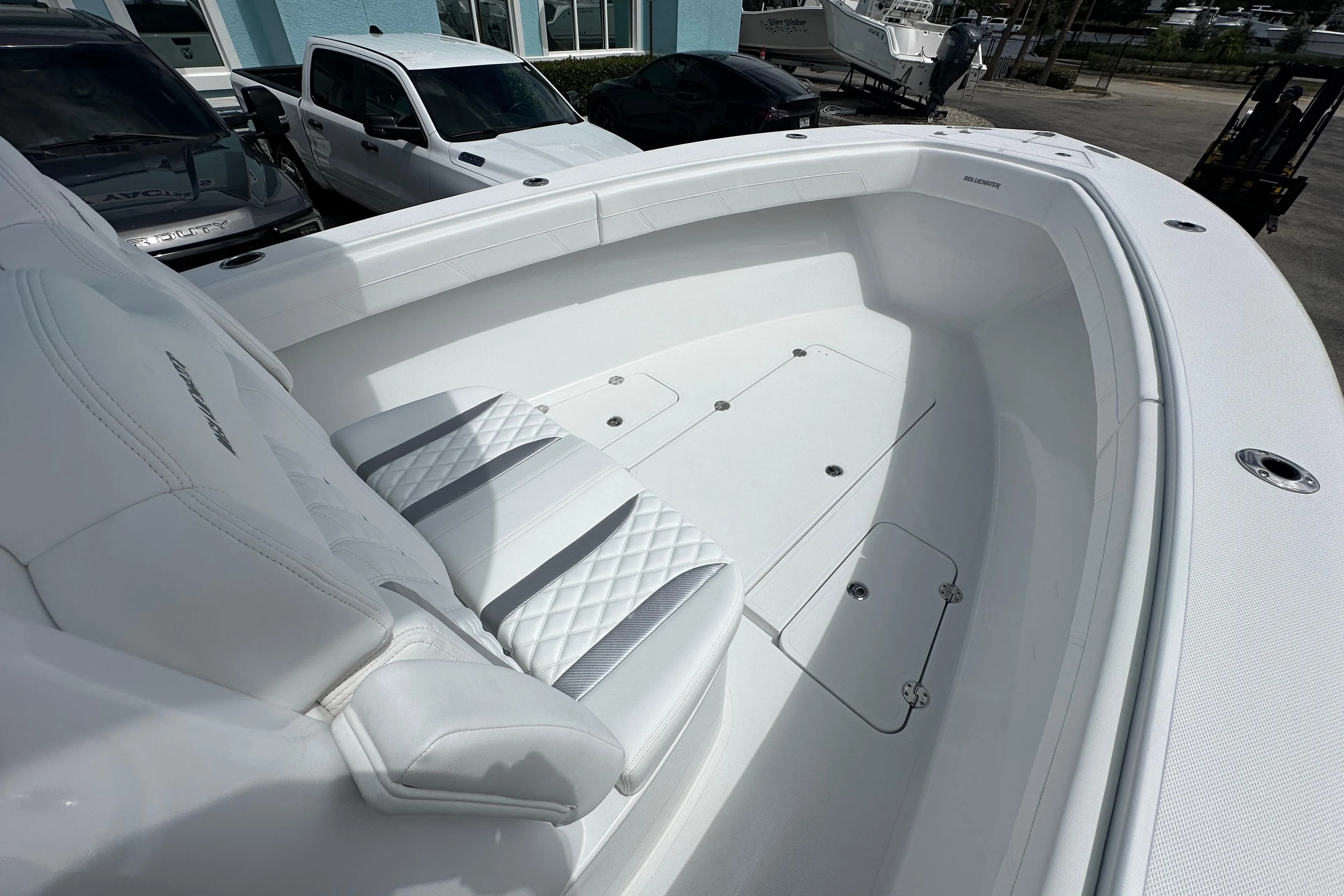 2026 Bluewater 25t boat interior with white seating and storage compartments.