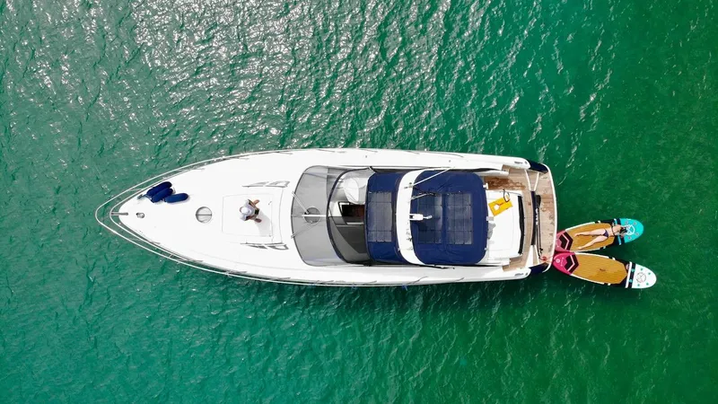  Yacht Photos Pics Aerial view of 2006 Absolute 45 yacht on turquoise water with paddleboards.