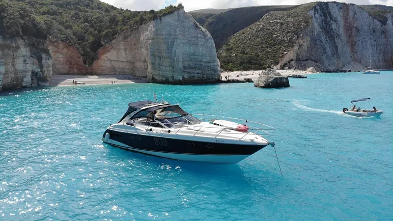  Yacht Photos Pics Luxury Absolute 45 yacht cruising in turquoise waters near rocky cliffs, 2006 model.