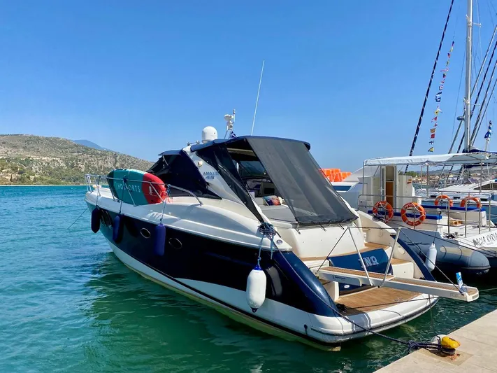  Yacht Photos Pics Luxury Absolute 45 yacht, 2006 model, docked in a serene marina setting.