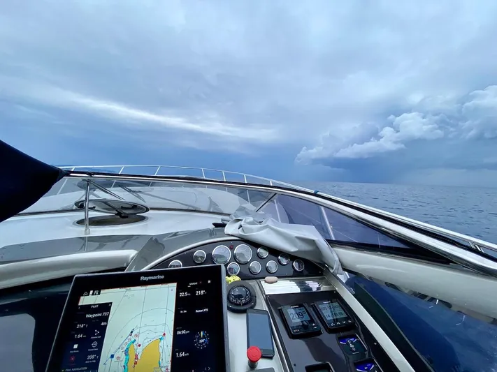  Yacht Photos Pics Cockpit view of 2006 Absolute 45 yacht navigating under cloudy skies.