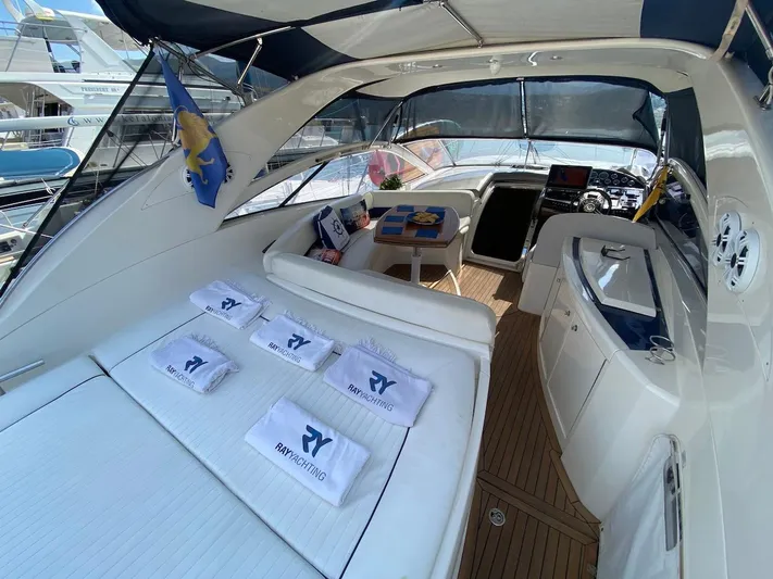  Yacht Photos Pics Luxurious 2006 Absolute 45 yacht interior with sunbed, towels, and helm station.