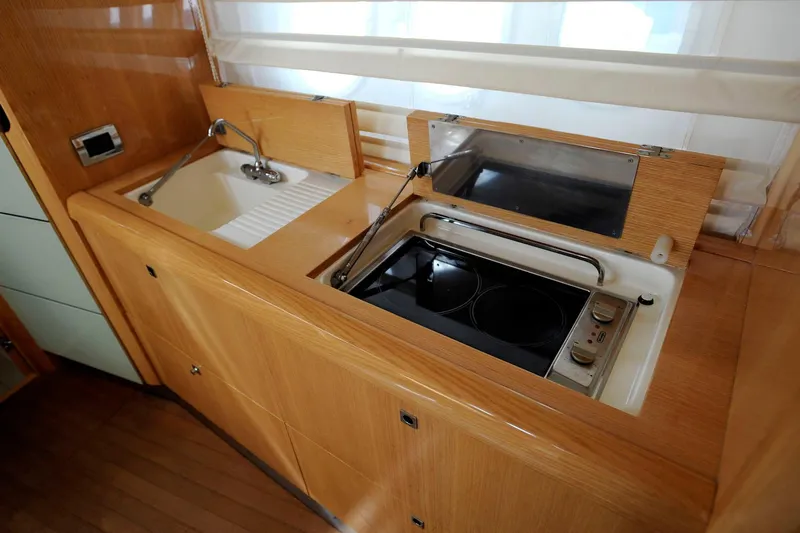  Yacht Photos Pics Compact kitchen area in a 2006 Absolute 45 yacht with sink and stove.