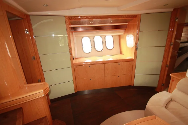  Yacht Photos Pics Luxurious interior of a 2006 Absolute 45 yacht with elegant wood finishes and porthole windows.