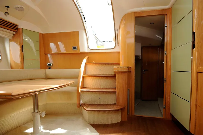  Yacht Photos Pics Luxurious interior of a 2006 Absolute 45 yacht with wooden finishes and seating area.