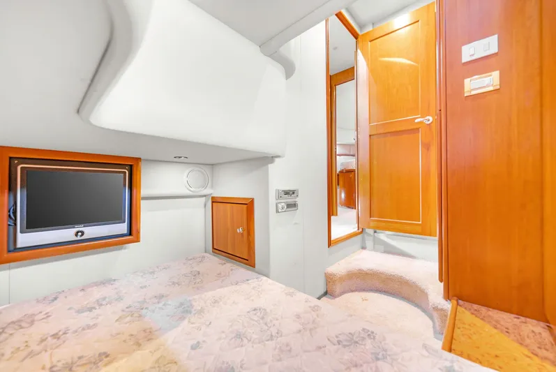 El Matador Yacht Photos Pics 2007 Silverton 45 Convertible yacht interior with TV, wooden cabinets, and cozy bedding.