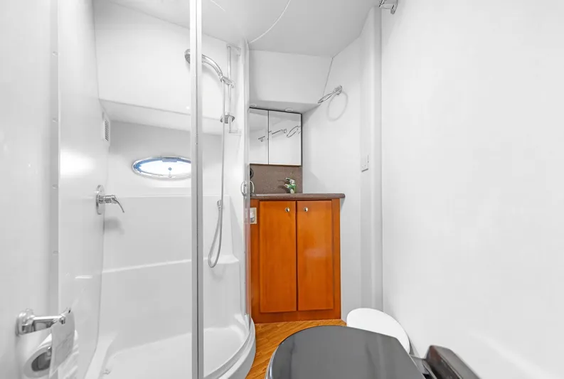 El Matador Yacht Photos Pics 2007 Silverton 45 Convertible yacht bathroom with shower, wooden cabinet, and modern fixtures.