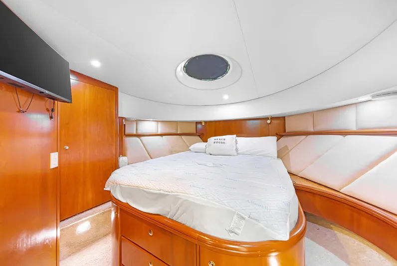 El Matador Yacht Photos Pics Luxurious bedroom interior of 2007 Silverton 45 Convertible yacht with elegant wood finishes.