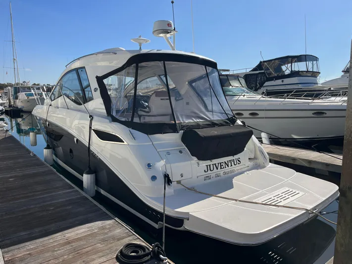  Yacht Photos Pics 2018 Sea Ray Sundancer 350 yacht docked at marina under clear blue sky.