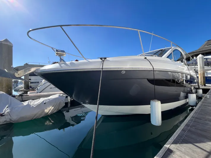  Yacht Photos Pics 2018 Sea Ray Sundancer 350 yacht docked at marina under clear blue sky.