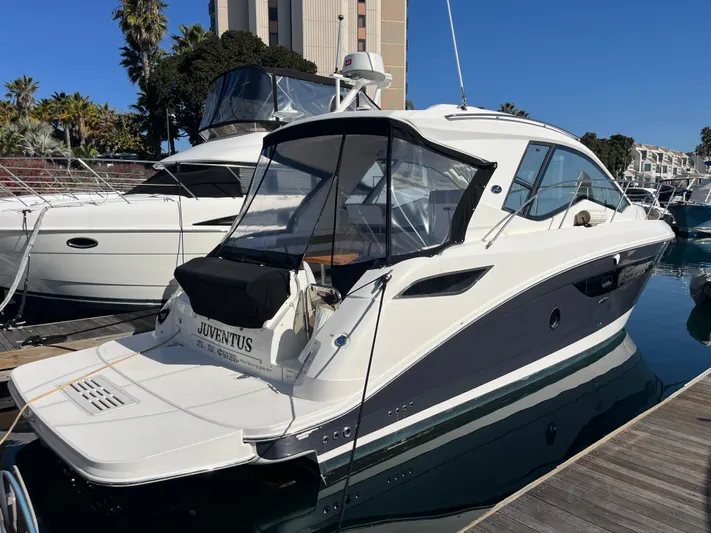  Yacht Photos Pics 2018 Sea Ray Sundancer 350 yacht docked at marina under clear blue sky.