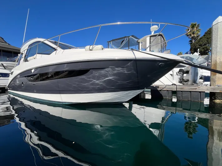  Yacht Photos Pics 2018 Sea Ray Sundancer 350 yacht docked, reflecting on calm water under clear blue sky.