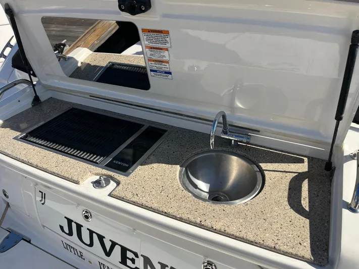  Yacht Photos Pics Outdoor kitchenette on 2018 Sea Ray Sundancer 350 yacht with sink and grill.