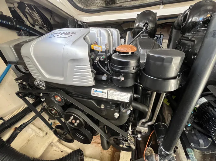  Yacht Photos Pics Engine compartment of a 2018 Sea Ray Sundancer 350 boat, showcasing detailed mechanical components.
