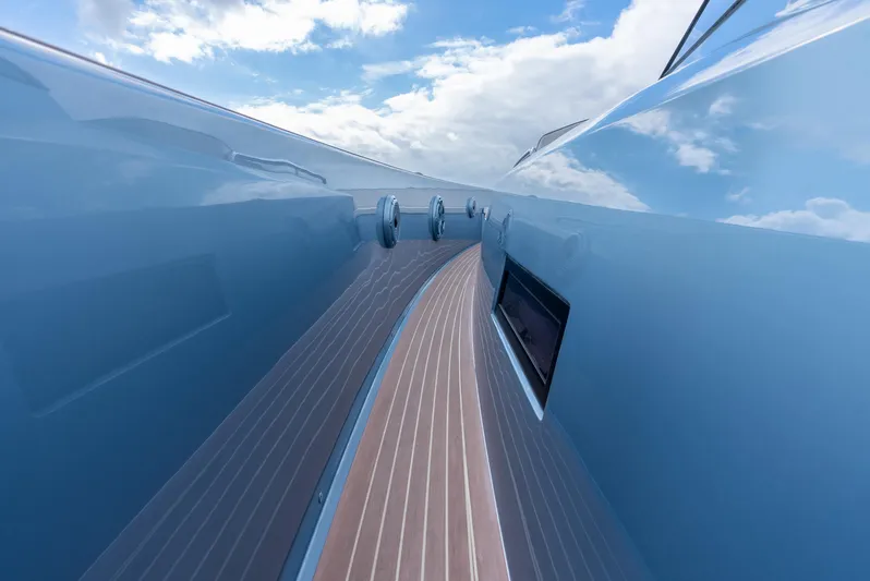 Exit Strategy Yacht Photos Pics Sleek 2023 Pardo Yachts 50 with polished blue exterior and wooden deck under a cloudy sky.