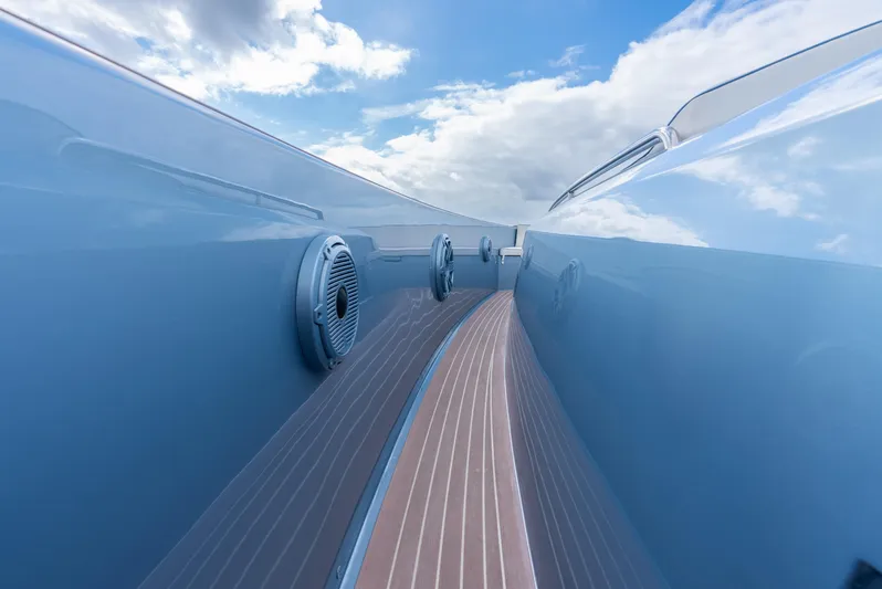 Exit Strategy Yacht Photos Pics Pardo Yachts 50, 2023 model, sleek blue exterior with wooden deck, under a cloudy sky.