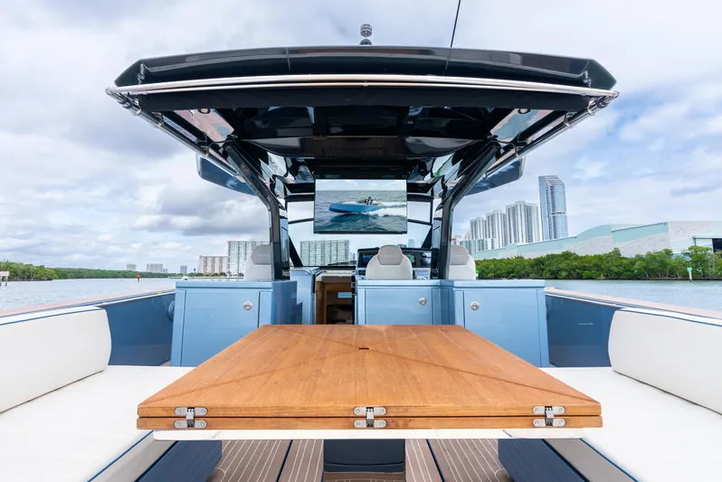 Exit Strategy Yacht Photos Pics 2023 Pardo Yachts 50 luxury yacht interior with wooden table and cityscape view.