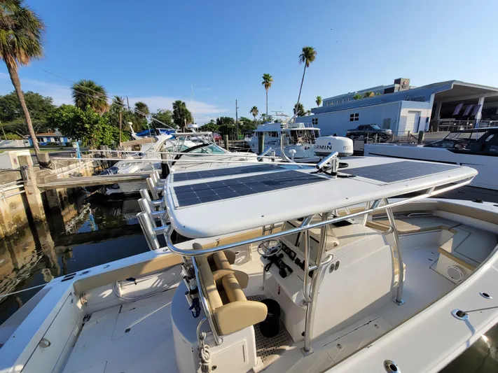 Every Effort Yacht Photos Pics 2008 Jupiter 34 FS boat docked at a marina with solar panels on the roof.