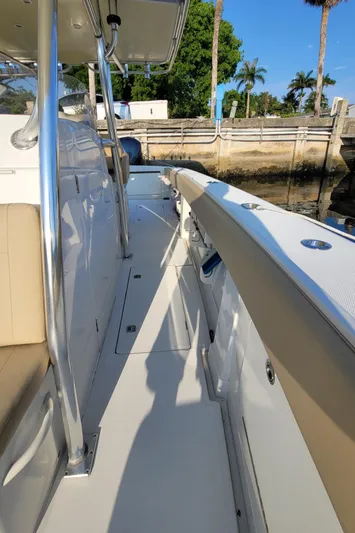 Every Effort Yacht Photos Pics 2008 Jupiter 34 FS boat deck with seating and railing, docked near palm trees.