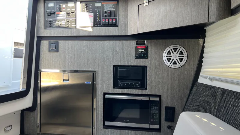  Yacht Photos Pics 2021 Monterey 385 SE interior with control panel, microwave, and speaker.