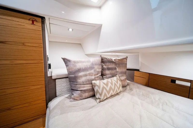  Yacht Photos Pics Luxurious cabin interior of 2023 Tiara Yachts 38 LS with plush bedding and modern design.