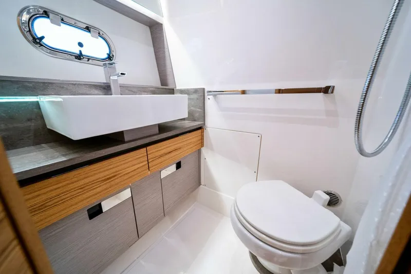  Yacht Photos Pics Modern bathroom in 2023 Tiara Yachts 38 LS, featuring sleek sink and compact toilet.