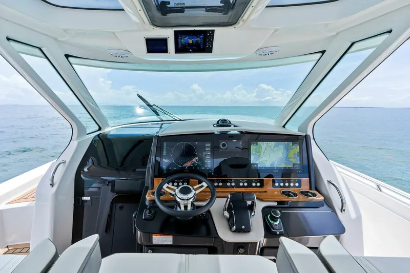  Yacht Photos Pics 2023 Tiara Yachts 38 LS helm with advanced navigation system and ocean view.