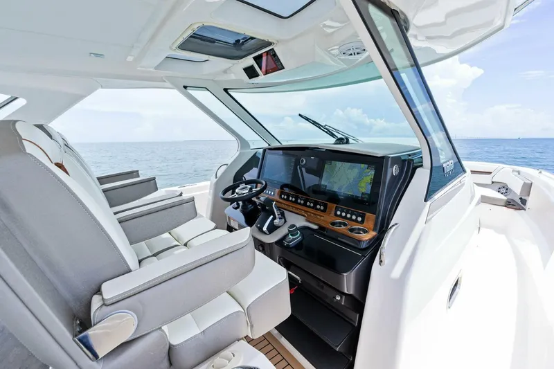  Yacht Photos Pics 2023 Tiara Yachts 38 LS helm with modern navigation system and luxurious seating.