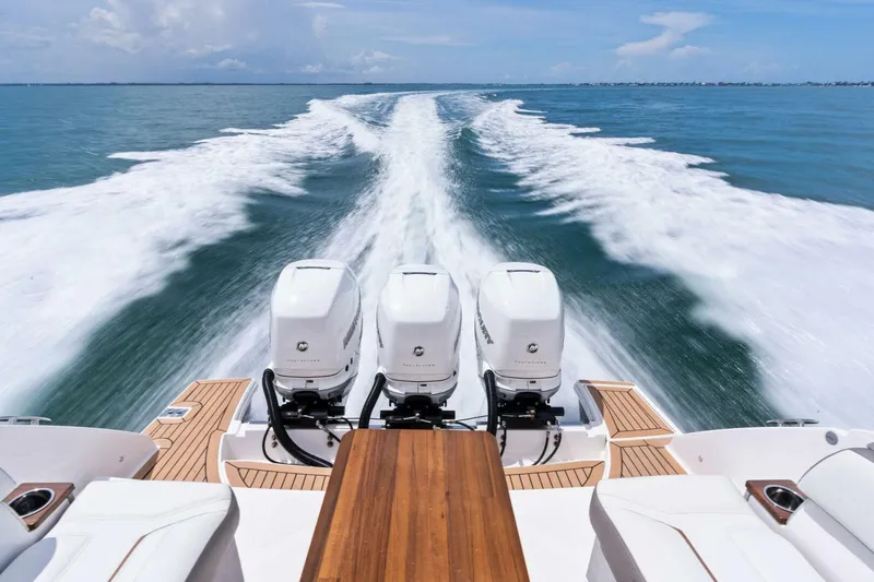  Yacht Photos Pics 2023 Tiara Yachts 38 LS cruising with triple engines, leaving a wake on open water.