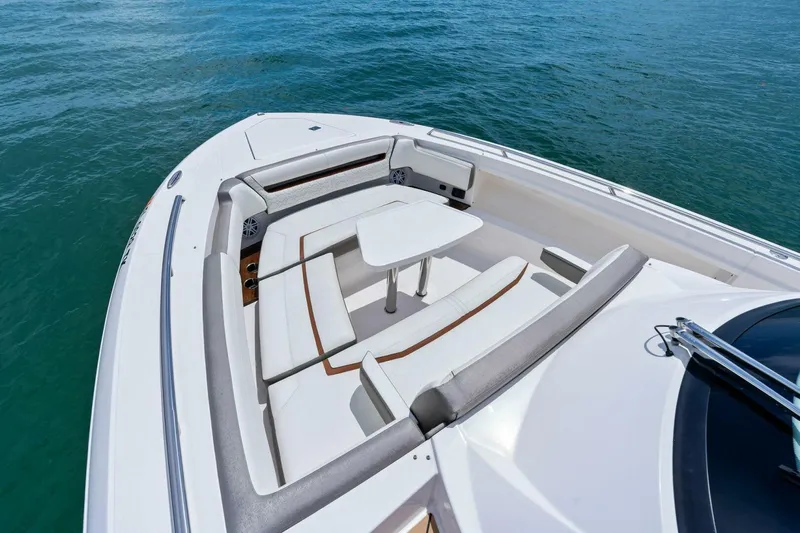  Yacht Photos Pics 2023 Tiara Yachts 38 LS boat with elegant seating and table on calm water.