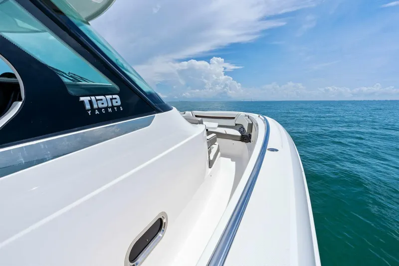  Yacht Photos Pics 2023 Tiara Yachts 38 LS cruising on open sea under clear blue sky.