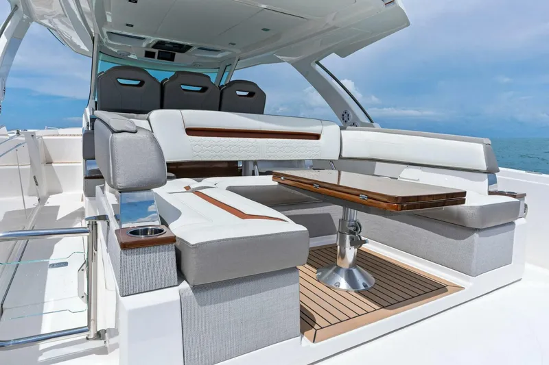 Yacht Photos Pics 2023 Tiara Yachts 38 LS interior with luxurious seating and wooden table.