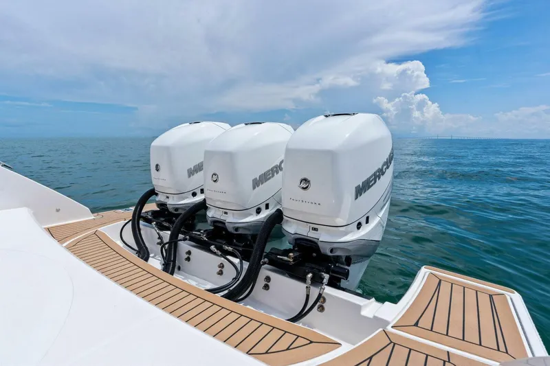  Yacht Photos Pics 2023 Tiara Yachts 38 LS with triple Mercury outboard engines on open water.