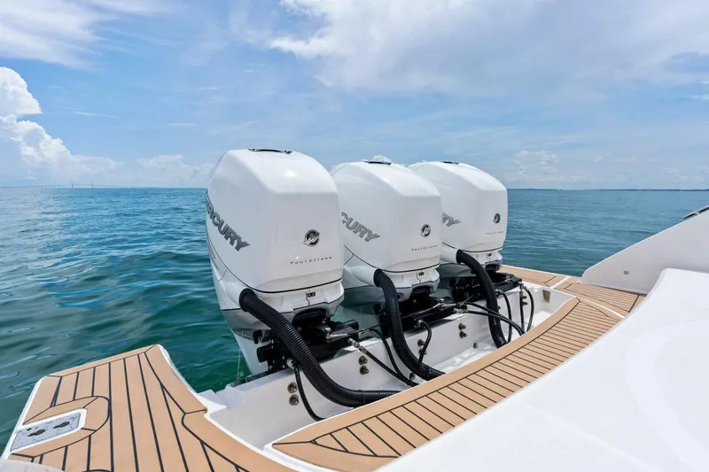  Yacht Photos Pics 2023 Tiara Yachts 38 LS with triple Mercury outboard engines on open water.