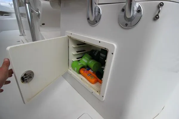 Every Effort Yacht Photos Pics Storage compartment on a 2008 Jupiter 34 FS boat with sunscreen and toiletries.