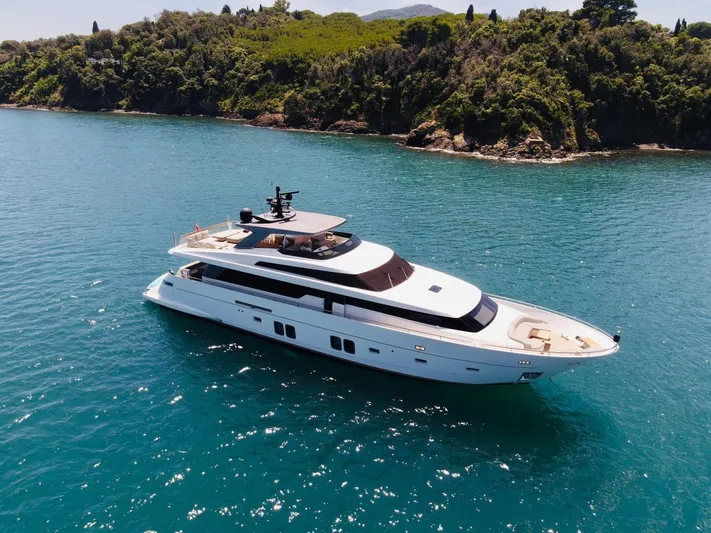  Yacht Photos Pics Sanlorenzo SL96 2016 yacht cruising in clear blue waters near a lush coastline.