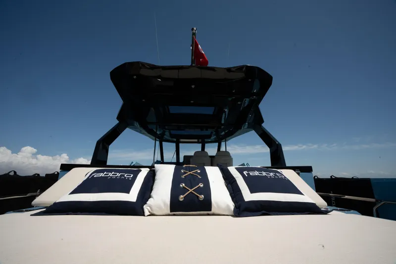 Therapy 1 Yacht Photos Pics 2024 Fabbro F45 yacht with branded cushions under a clear blue sky.