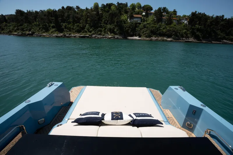 Therapy 1 Yacht Photos Pics 2024 Fabbro F45 yacht deck with cushions, overlooking serene water and lush shoreline.