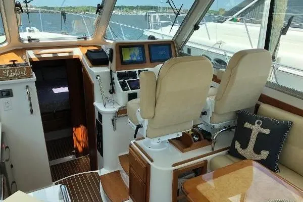  Yacht Photos Pics Interior of 2018 Back Cove Downeast 37 boat with helm and seating area.