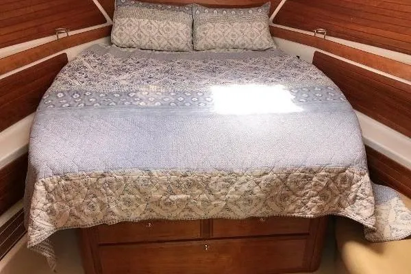  Yacht Photos Pics Cozy cabin interior of 2018 Back Cove Downeast 37 with elegant bedding and wood paneling.